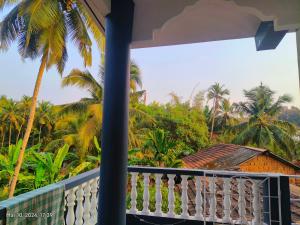 a view from the balcony of a resort with palm trees at Pagis place in Canacona