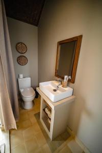 a bathroom with a white sink and a toilet at Life Club Beach Resort in Quy Nhon
