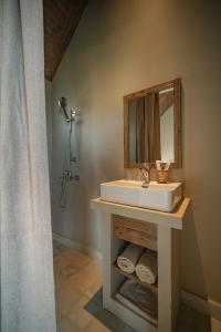 a bathroom with a sink and a mirror at Life Club Beach Resort in Quy Nhon