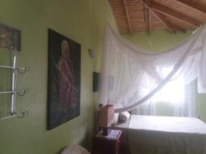 a bedroom with a bed and a window at A Private Room in Paradise, Vieux Fort in Vieux Fort