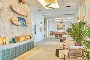 a lobby of a resort with a surfboard on the wall at THE SENAGAJIMA STORYLINE in Tomigusuku