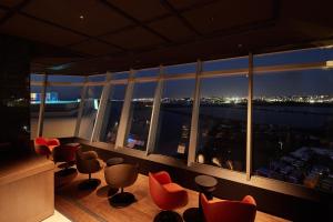 a room with chairs and a view of a city at THE SENAGAJIMA STORYLINE in Tomigusuku