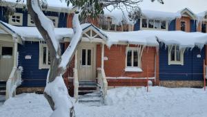 a blue house with snow on top of it at Brockhoff Lachen in Mount Hotham