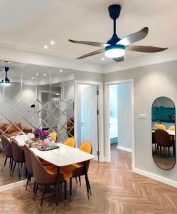 a dining room with a table and a ceiling fan at Altara Quy nhơn Residences Wins in Quy Nhon