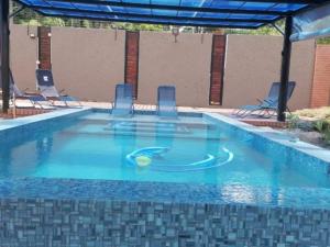a pool with chairs and a ball in the water at 30 on Bergh in Louis Trichardt