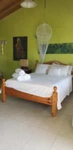 a bedroom with a large bed with a net at A Private Room in Paradise, Vieux Fort in Vieux Fort