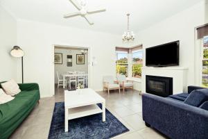 uma sala de estar com um sofá e uma lareira em 6 BR House Near Adelaide Airport em West Richmond