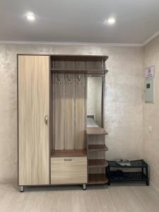 a room with a closet with a shelf and stairs at Comfort plus in Almaty