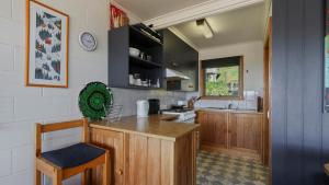 a kitchen with wooden cabinets and a counter top at Fountains 6 in Mount Hotham +1 photo