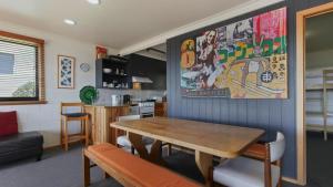 a kitchen and dining room with a wooden table at Fountains 6 in Mount Hotham