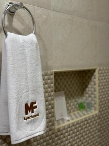 a towel hanging on a towel rack in a bathroom at MFAPARTMENT in Al Budayyiâ€˜