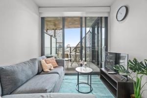 a living room with a couch and a table at Taffy on Realm RundleMall Pool&Gym EasyLifestyle in Adelaide +27 photos