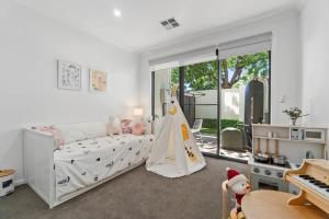 a childs bedroom with a crib and a piano at New Luxury Stylish Elegant Townhouse for Families in Broadview