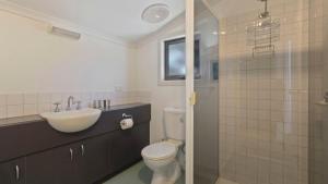 a bathroom with a toilet and a sink and a shower at Karoondah 7 in Mount Hotham +8 photos