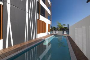 a swimming pool on the side of a building at Surf's Up Stunning Paradise Apartment Serenity in Gold Coast