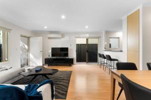 a living room with a couch and a table at Family friendly CBD 3BR Apt Hurtle Square in Adelaide