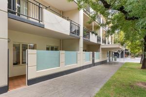 a building with a balcony on the side of it at Family friendly CBD 3BR Apt Hurtle Square in Adelaide
