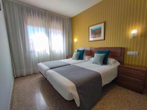 Posteľ alebo postele v izbe v ubytovaní Hotel Arcos Catedral