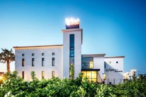 a white building with a clock tower in front of it at Jeju Attracting36 5 Individual Pension in Jeju +3 photos