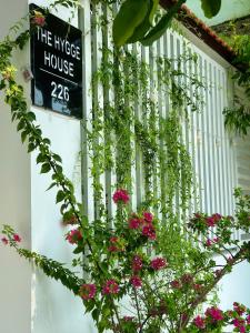 a sign on the side of a house with flowers at The Hygge House in Da Nang