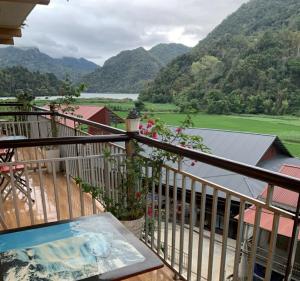 a balcony with a view of a valley and mountains at Pac Ngoi Village's homestay - Hoàng Nguyên in Bak Kan