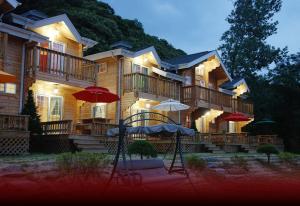 a large house with umbrellas in front of it at dagagada pension in Hwach'ŏn