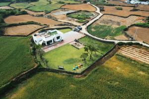 an aerial view of a house in a field at Jayouhaneun private house in Jeju
