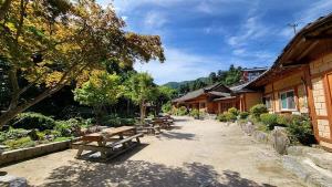 a group of benches sitting next to some buildings at Gapyeong Dume Mountain Pension in Gapyeong