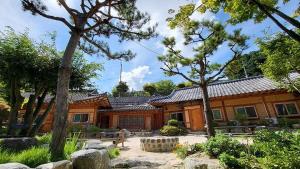 a wooden house with trees in front of it at Gapyeong Dume Mountain Pension in Gapyeong