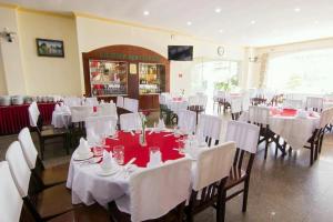 a banquet hall with white tables and white chairs at Victory Hotel Old Wing in Vung Tau +29 photos