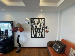 a living room with a couch and a picture on the wall at Five Stars Suites - Park - Quito in Quito