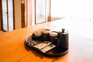 a tray with three coffee cups on a table at Goheung Namsoonjae Hanok Stay in Goheung