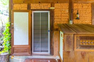 an open door of a house with a window at Hadong kkotdam pension in Hadong