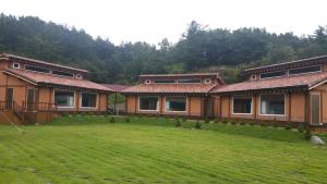 a house with a large yard in front of it at Upo healing vill in Changnyeong