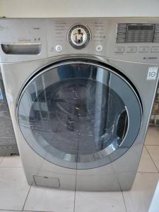 a silver washing machine sitting on a floor at Ruby's Place in Boscobel