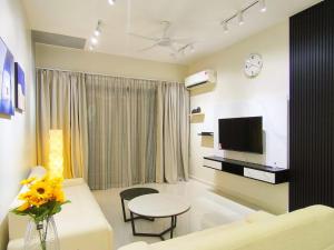 a living room with a couch and a tv at Country Garden J Agape Homestay JB COZY 1006-4A in Johor Bahru