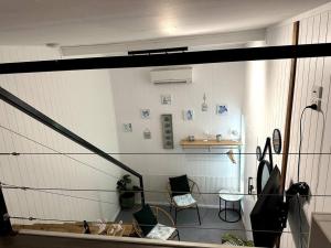 a room with a staircase and a table and chairs at NEW! Sea Joley Tiny Home in Nelly Bay +36 photos