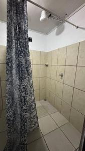 a bathroom with a shower with a shower curtain at 444, Rincón de paz in Alajuela City