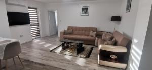 a living room with a couch and a table at Sweet Home in Miercurea-Ciuc