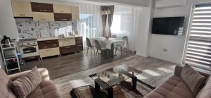 a living room with a couch and a table at Sweet Home in Miercurea-Ciuc