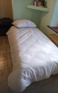 a white bed with a pillow on top of it at Forest 104 in Vielsalm