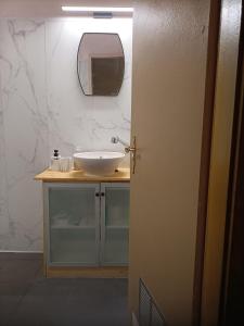 a bathroom with a sink and a mirror at Forest 104 in Vielsalm
