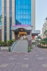 a building with stairs in front of a building at Hotel Studio Estique in Pune