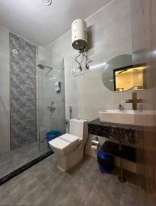 a bathroom with a toilet and a sink and a shower at AK VILAS - BEST BUDGETED HOTEL IN JAIPUR in Jaipur