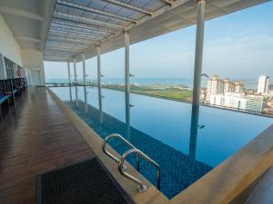 a swimming pool with a view of the city at The Straits Melaka by Perfect Host in Melaka