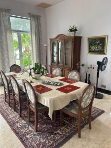 a dining room with a table and chairs and a table at Luxery Villa Sea Side in Port Dickson