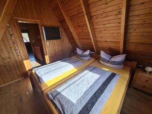 a bedroom with two beds in a log cabin at Flower in Carolinensiel in Carolinensiel