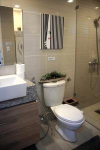 a bathroom with a toilet and a sink and a shower at McKinley Hills BGC Taguig City Condo in Manila