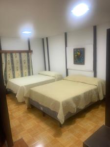 una camera con due letti di hotel Las Cabañitas 8873-3748 a Managua
