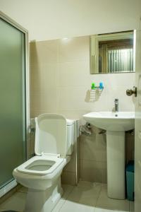 a bathroom with a toilet and a sink at Country Club Nuwara Eliya in Nuwara Eliya +39 photos